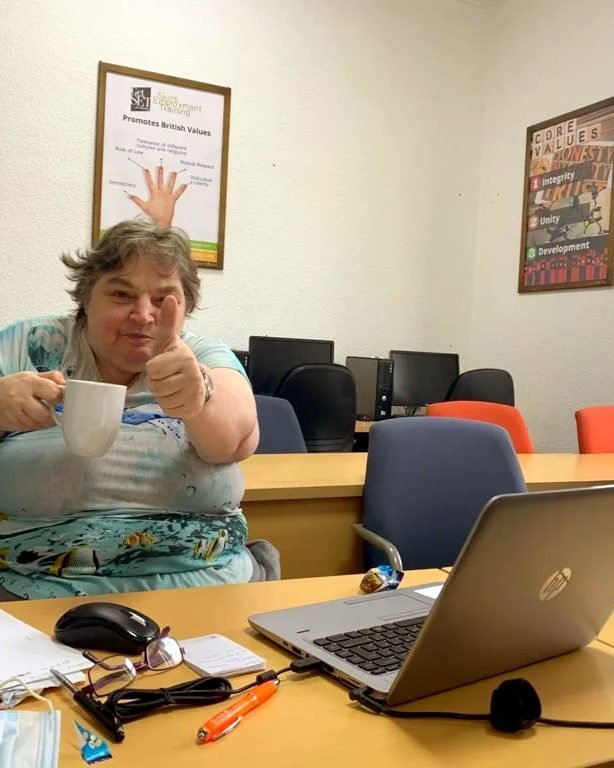 A learner working on a laptop at a Positive Smiles session